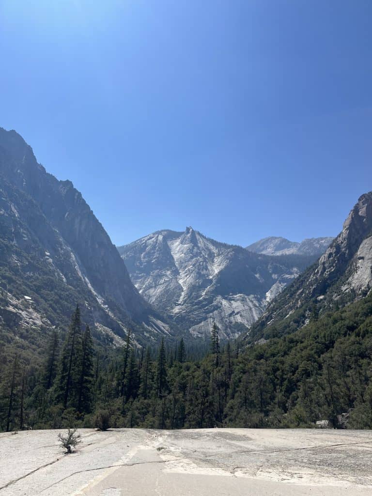 Granite canyon walls and forested valley along the Mist Falls Trail in Kings Canyon National Park, California.